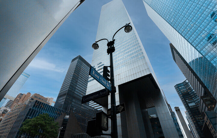 View of a tall building with mirrored windows.