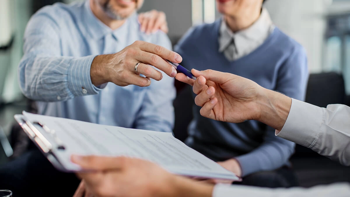 Group of people signing a contract.