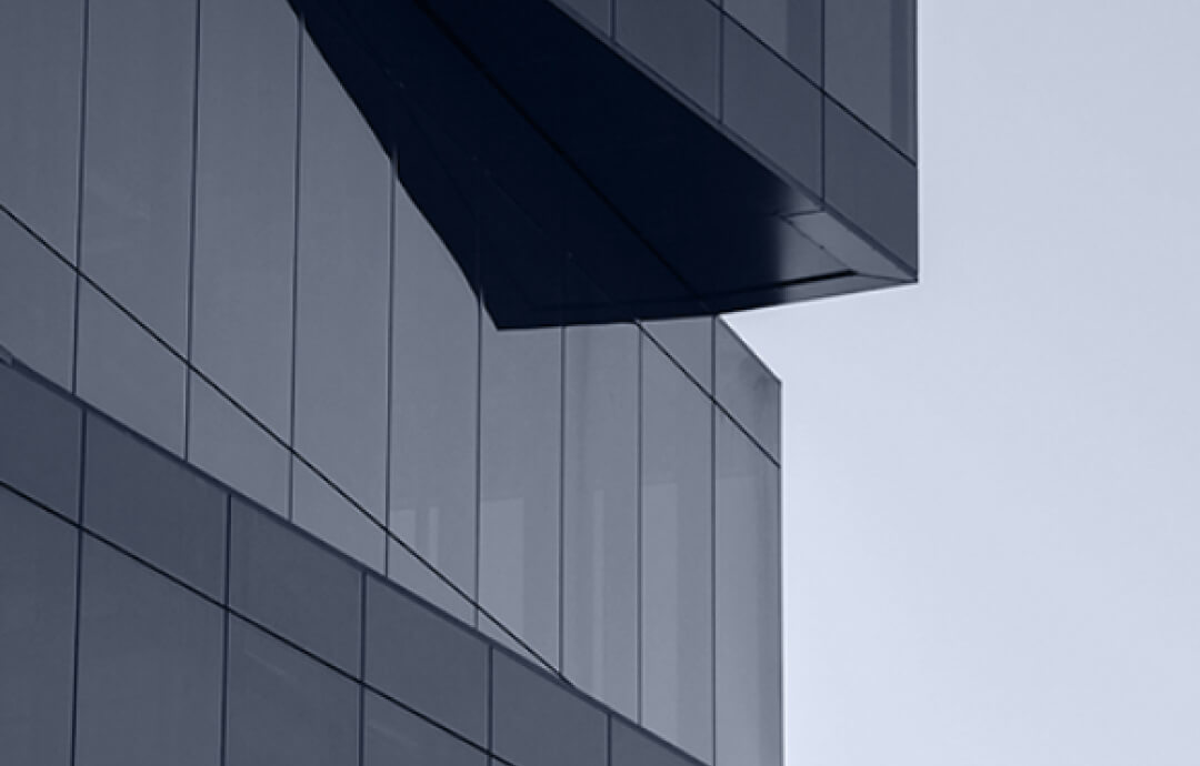 Close-up of modern building facade with clean lines and dark glass.