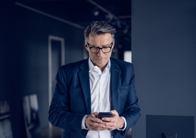 Man in suit looking at cell phone