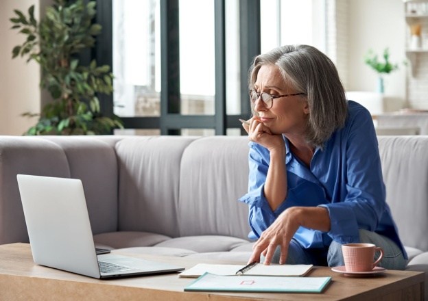 Woman wearing glasses working on notebook